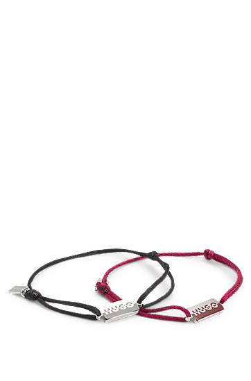 Two cord cuffs with rectangular metal plaques