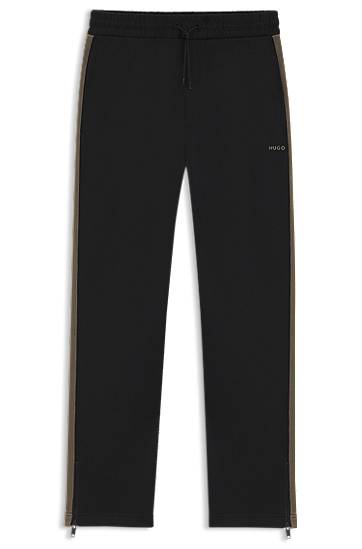 Relaxed-fit tracksuit bottoms with logo tape and ankle zippers